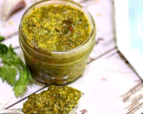 close up of chimichurri sauce in a jelly jar