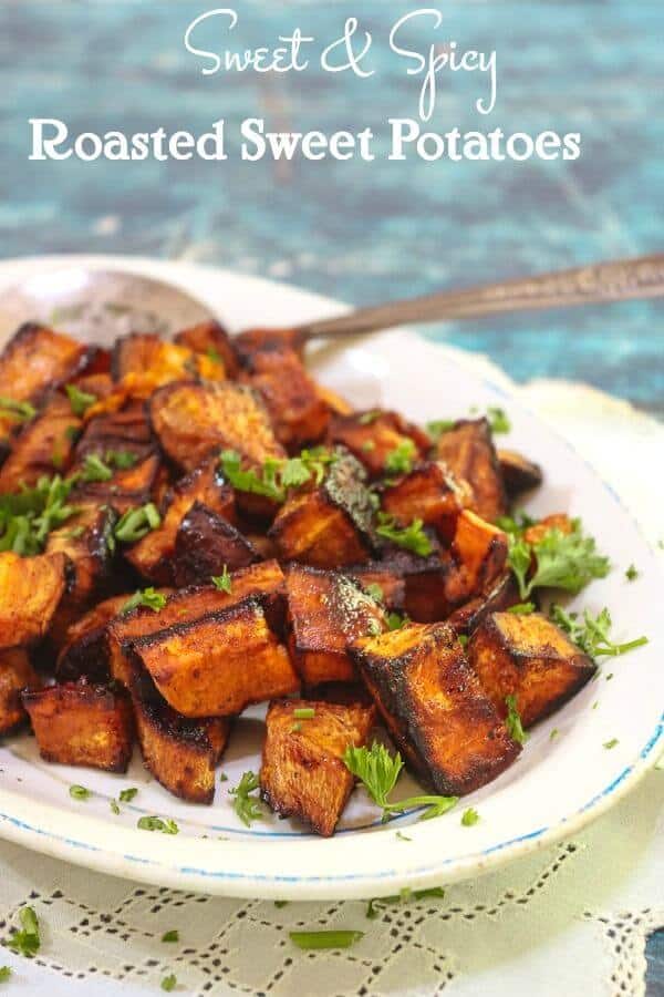 A platter of bright oranges roasted sweet potatoes garnished with parsley. Title image