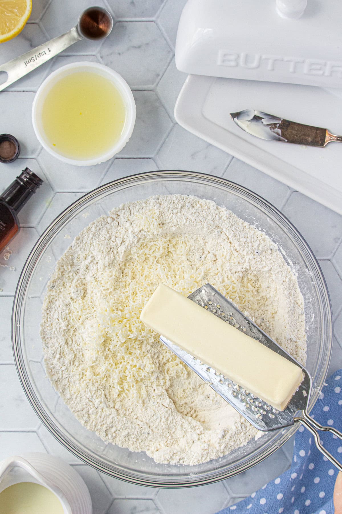 Butter being grated into the flour mixture.