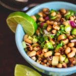 Overhead view of black eyed pea salad with a lime.