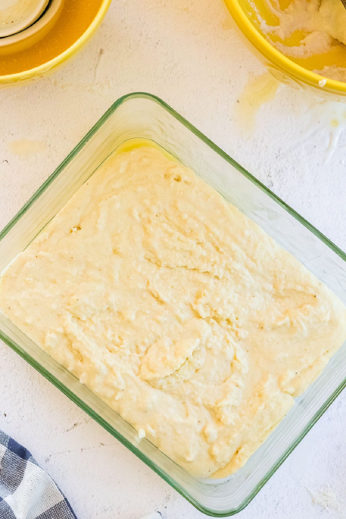 Batter is in a glass pan ready to bake.