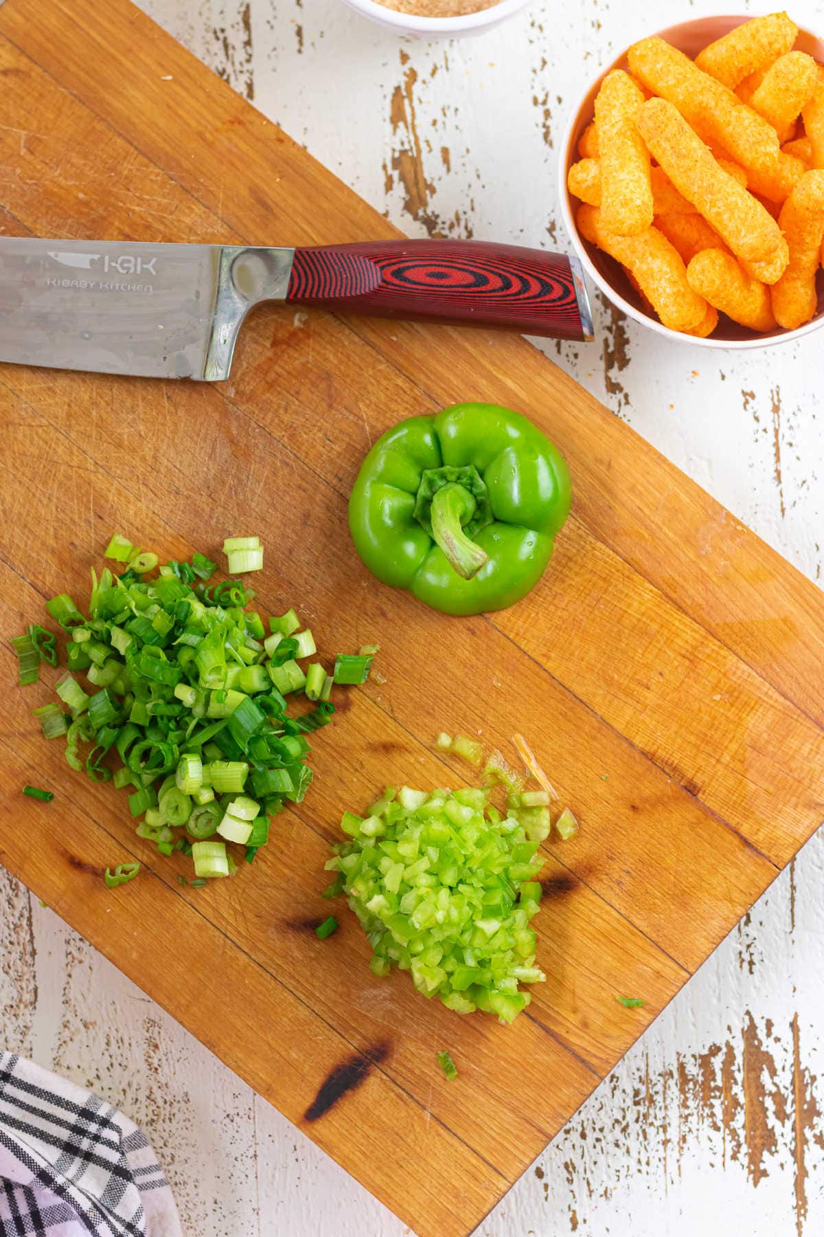 Chopping veggies for the cheese ball.