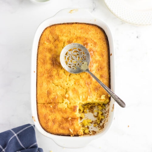 Overhead view of cornbread with a serving removed.