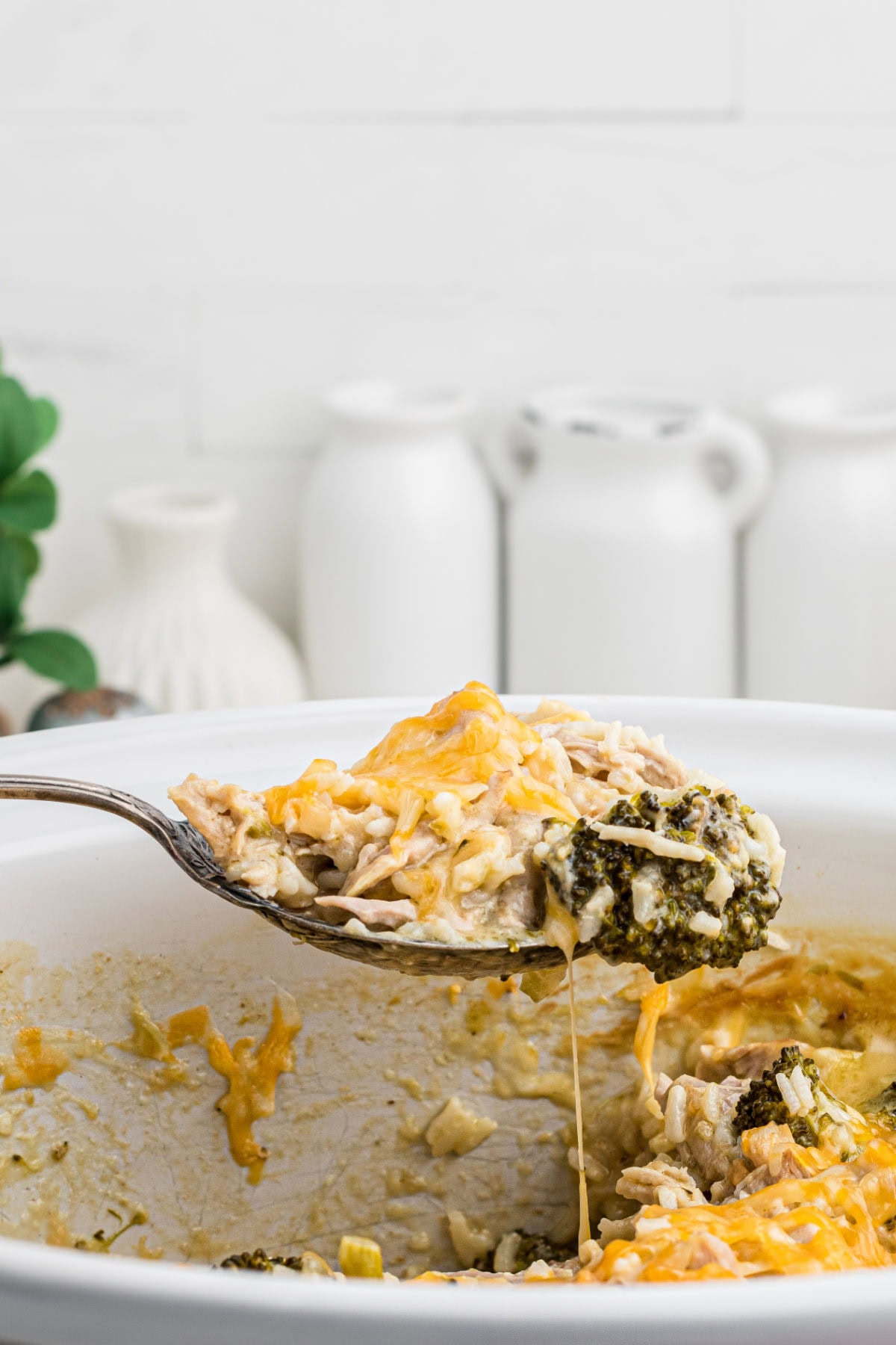 A spoonful of casserole being served from the slow cooker.