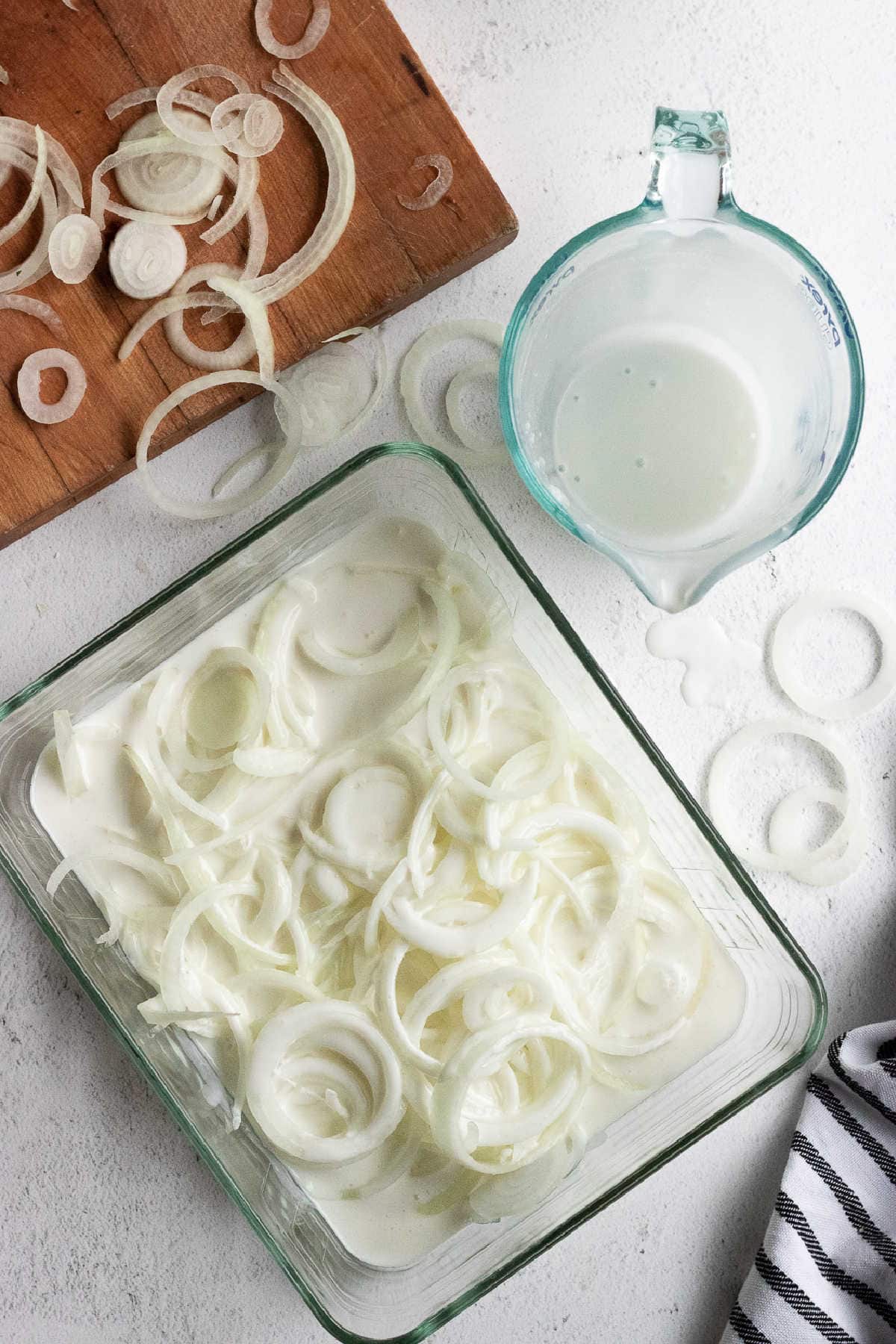 SLiced onions soaking in buttermilk.