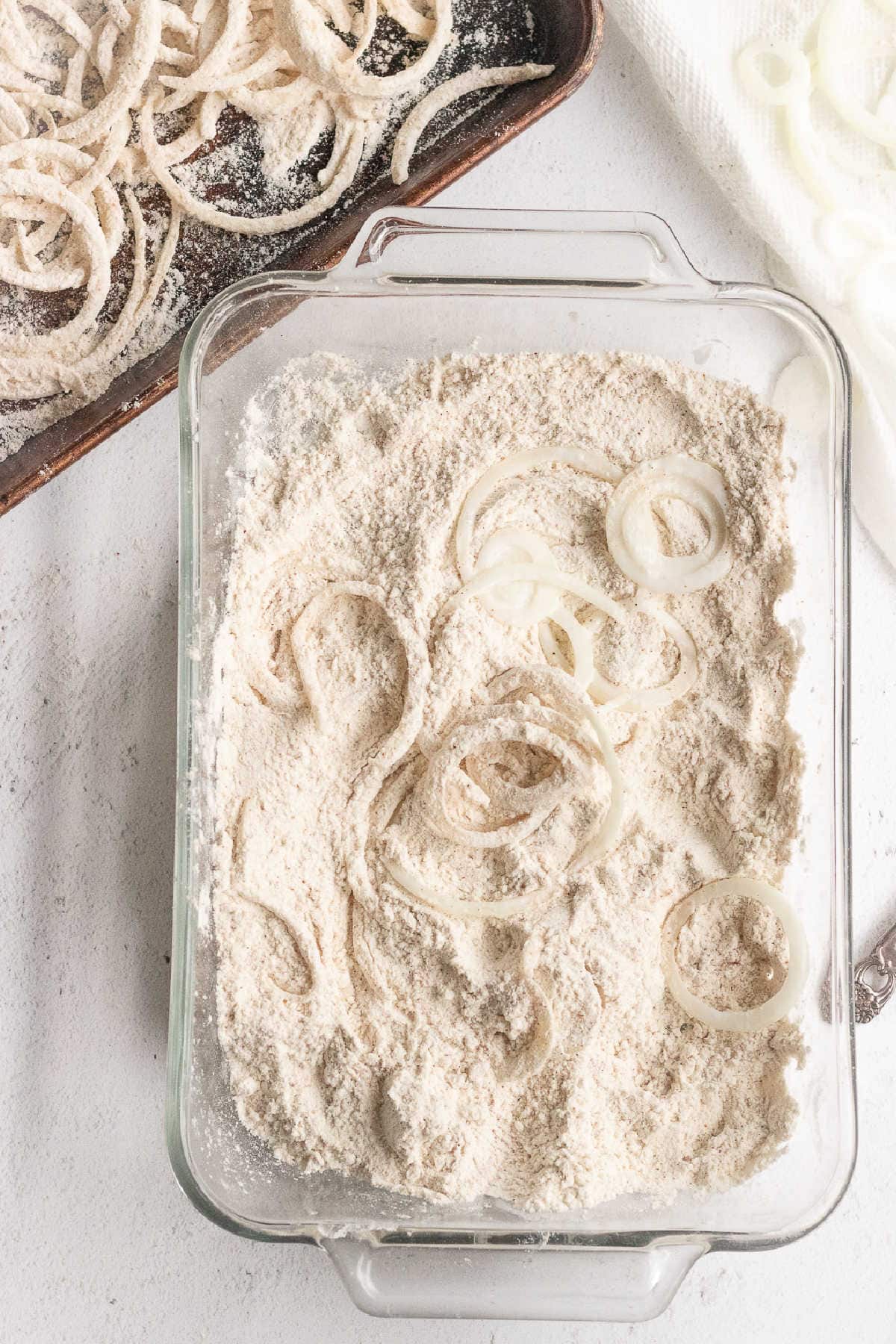 Onions being dredged in flour mixture.