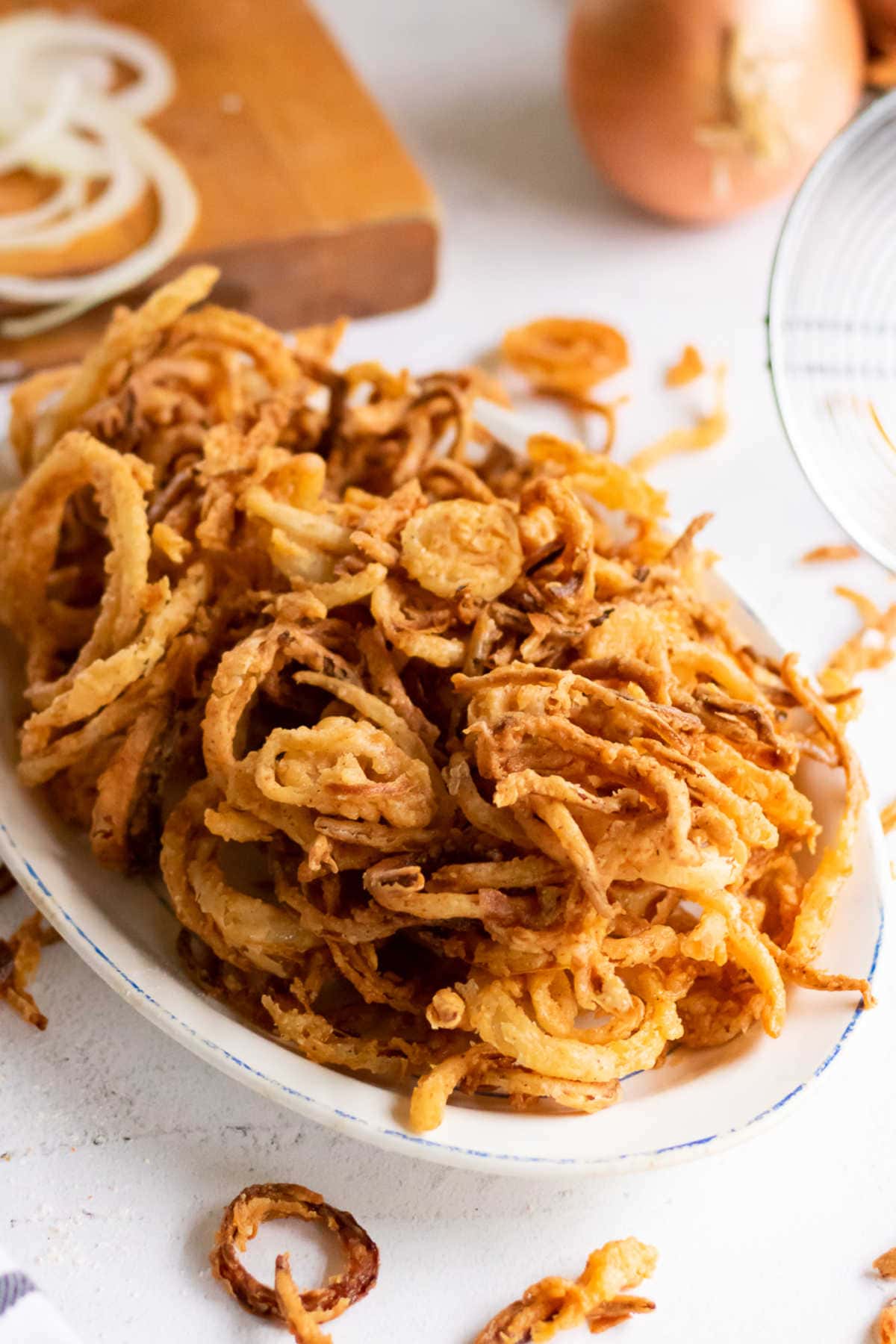 A platter full of crispy French fried onions.