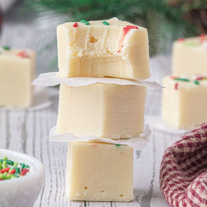 A stack of white fudge on a table showing the creamy interior.