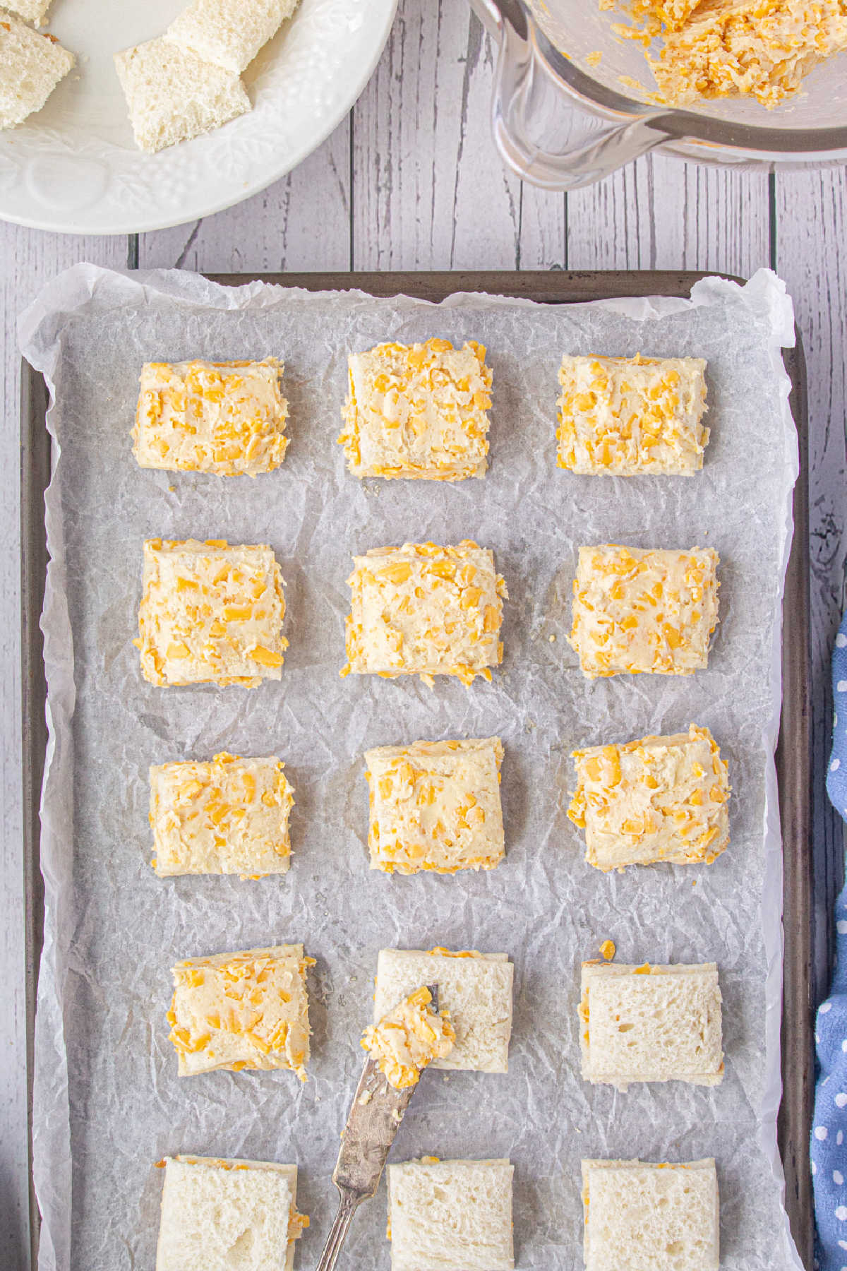 Tops of the bread squares are covered with more of the cheese mixture.