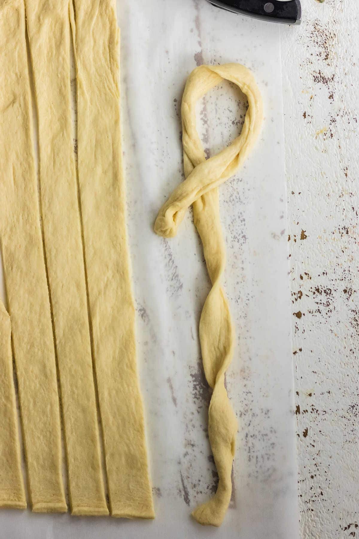 Crescent roll dough cut in strips.