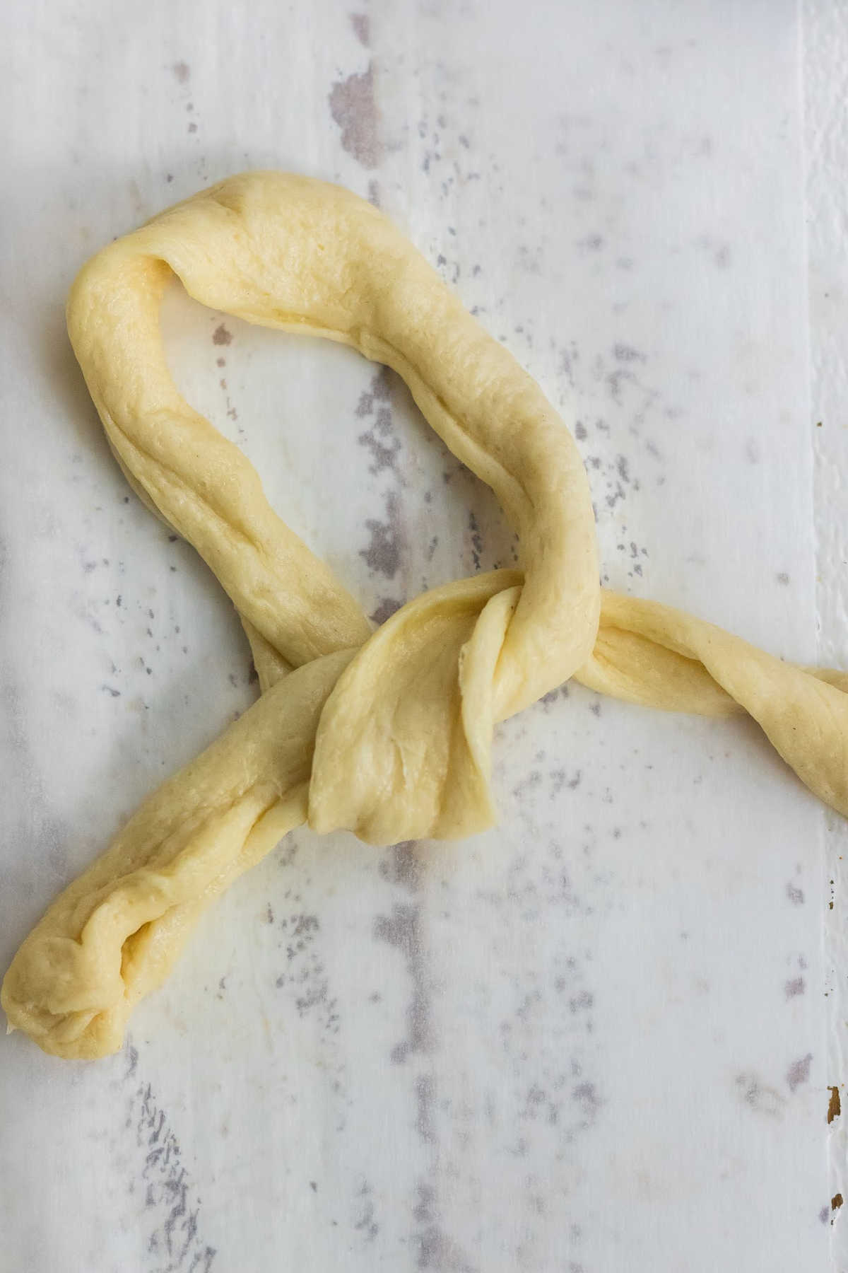 Strip of dough being formed into a circle.