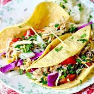 Close up of tequila chicken tacos on a plate.