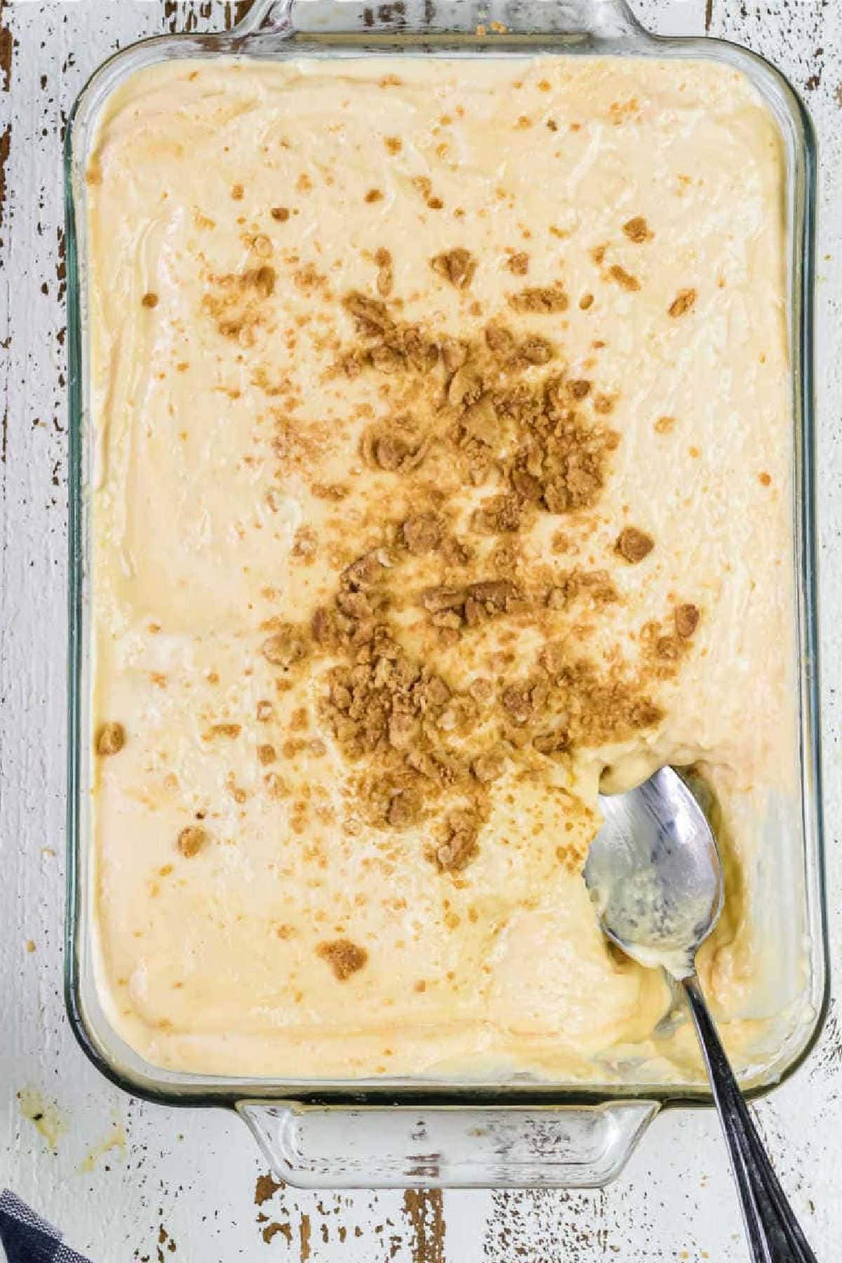 Overhead view of banana pudding with a spoon in it ready to be served.