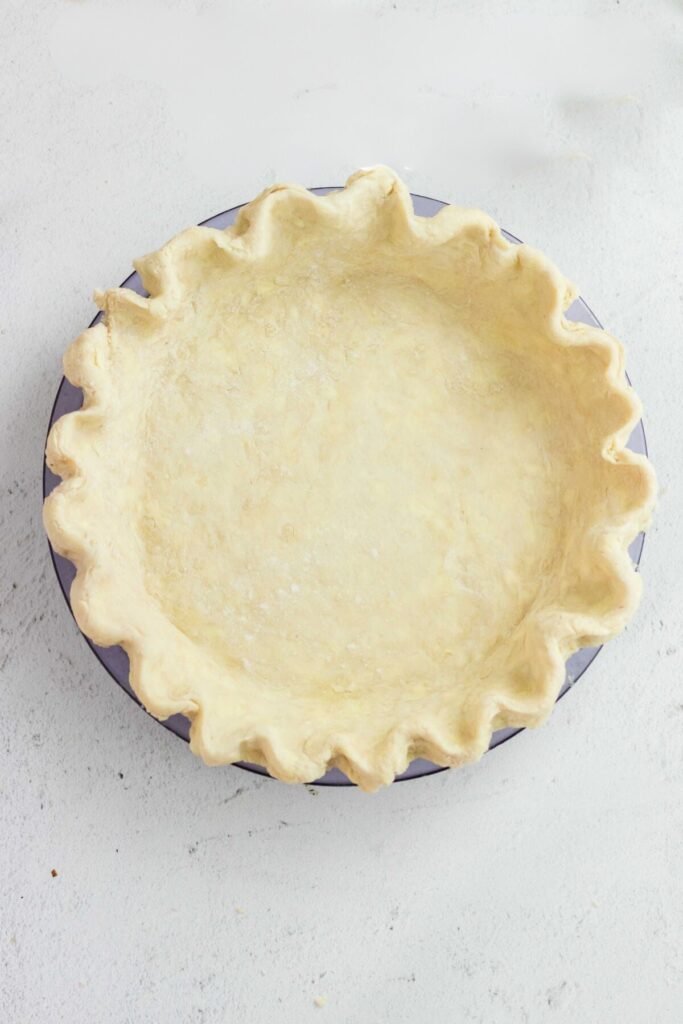 Unbaked pie crust in a pie pan.