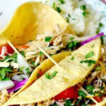 Closeup of tequila lime chicken tacos with a title text overlay for Pinterest.