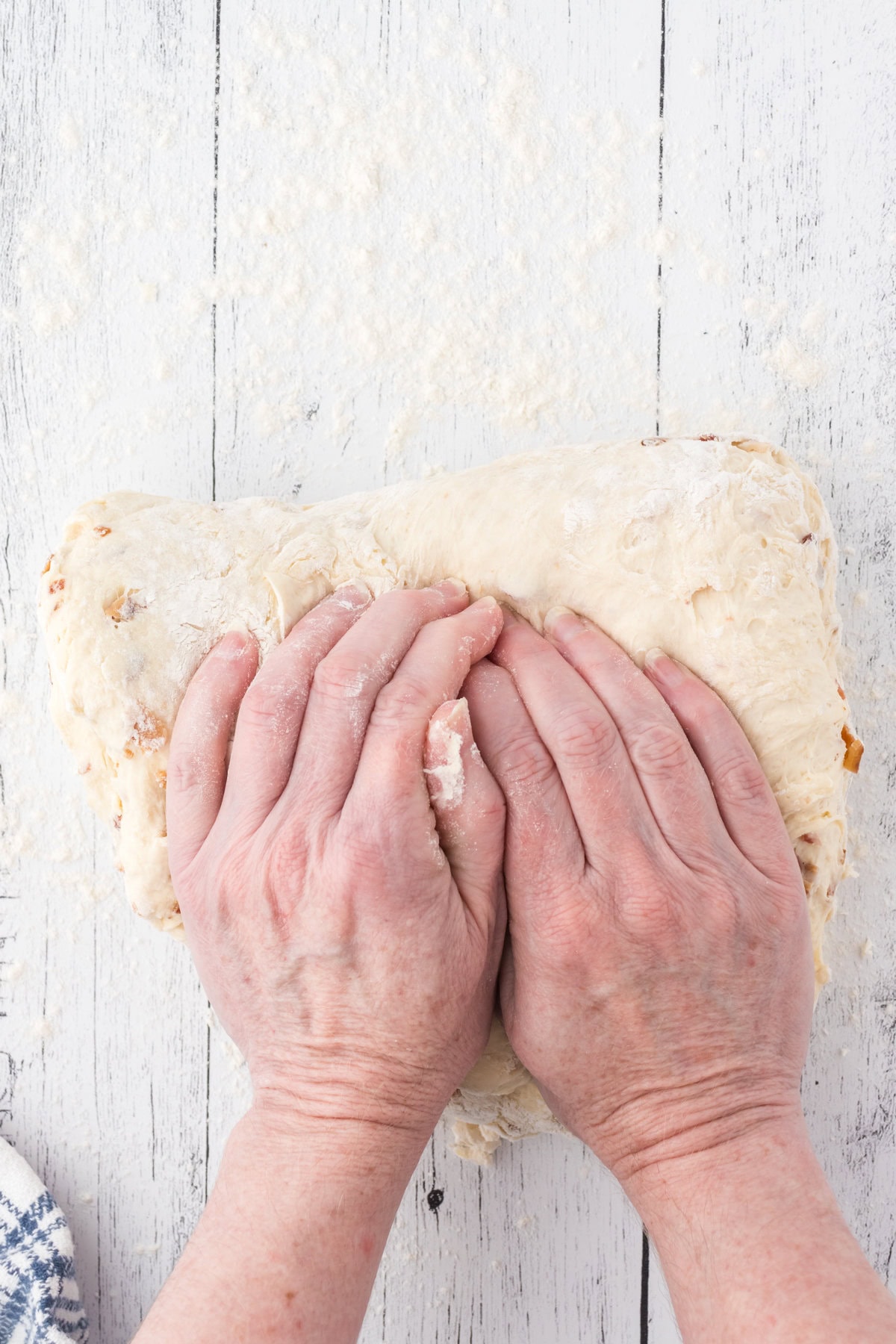 Hands kneadng the bread dough.