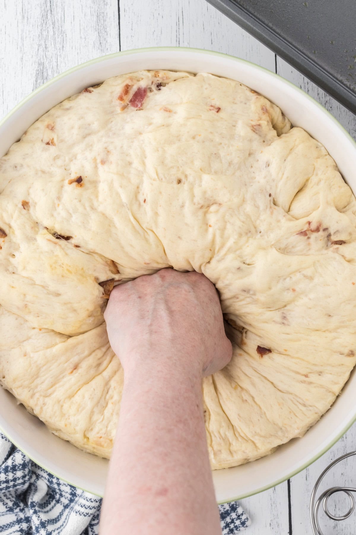Punching down risen dough.