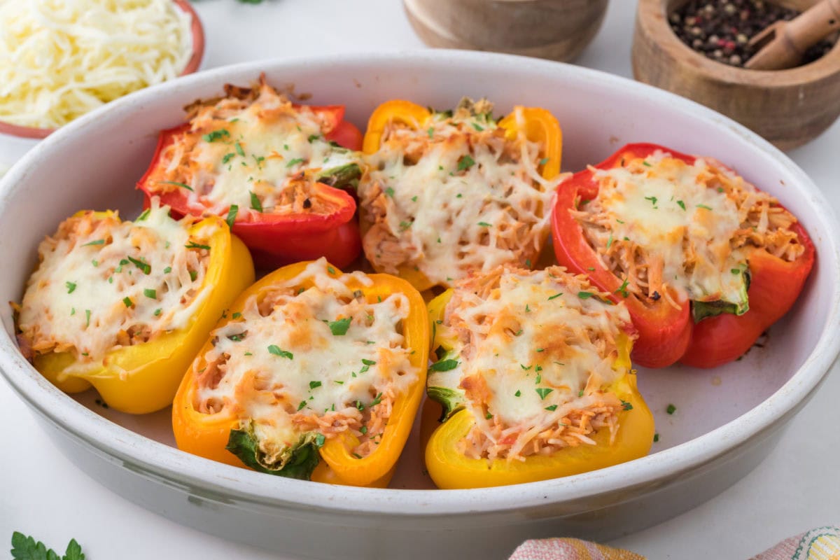 Finished chicken stuffed peppers in a casserole dish on the table.