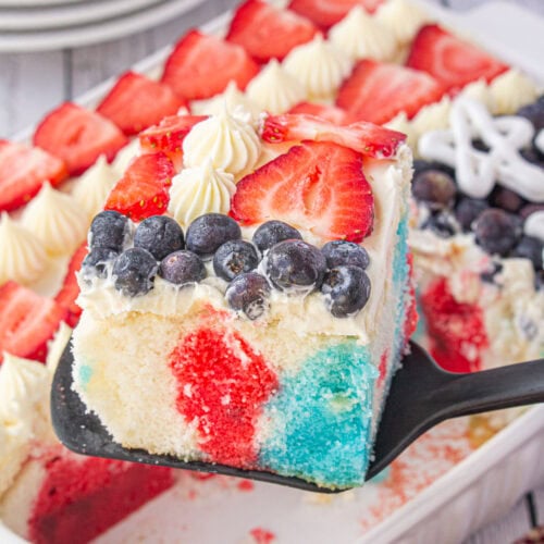 A square of the red, white, and blue Jello poke cake being served.