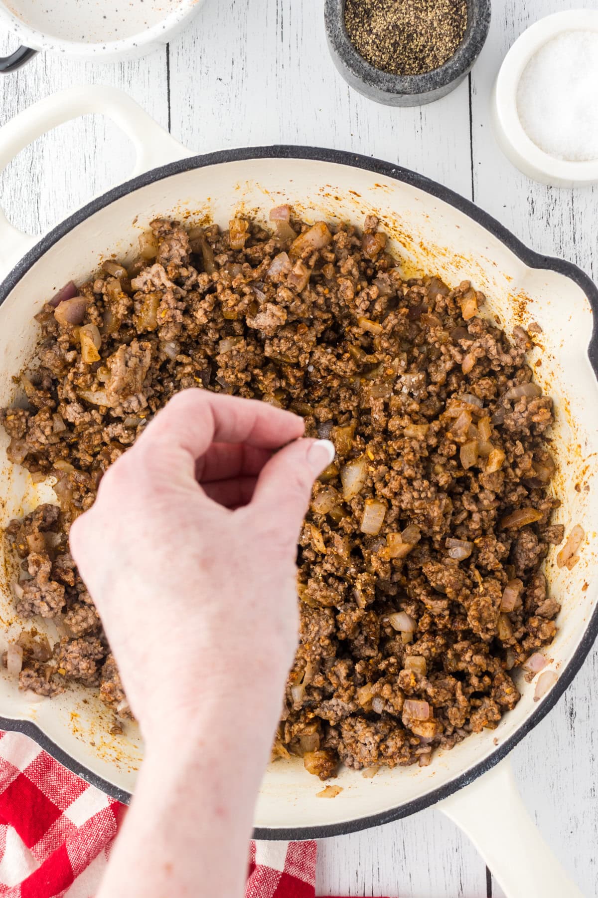 Add the taco seasoning to the ground beef in a skillet.