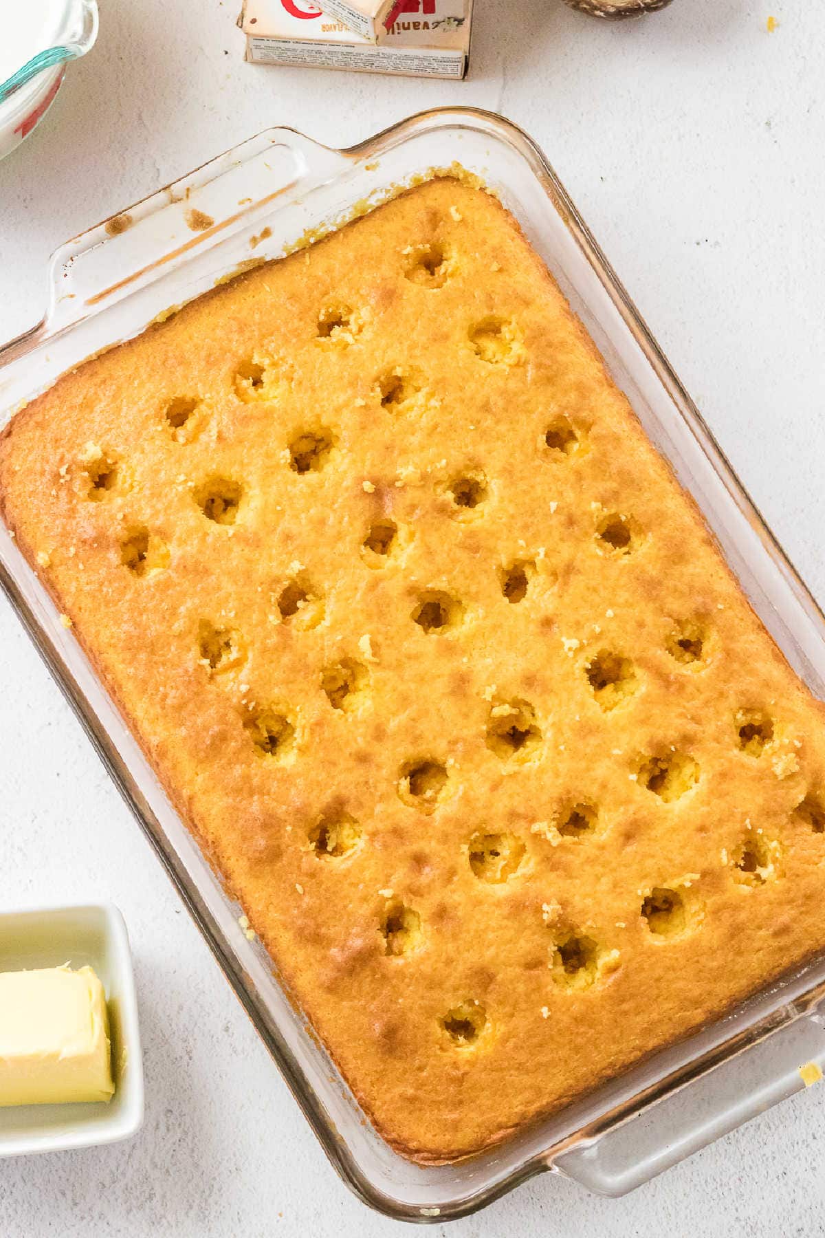 Yellow cake with holes poked in the top.