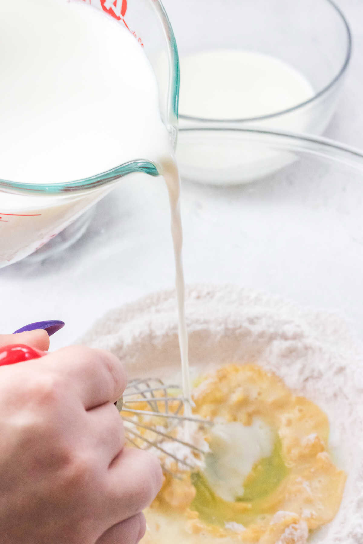 Stirring milk into instant pudding mix.