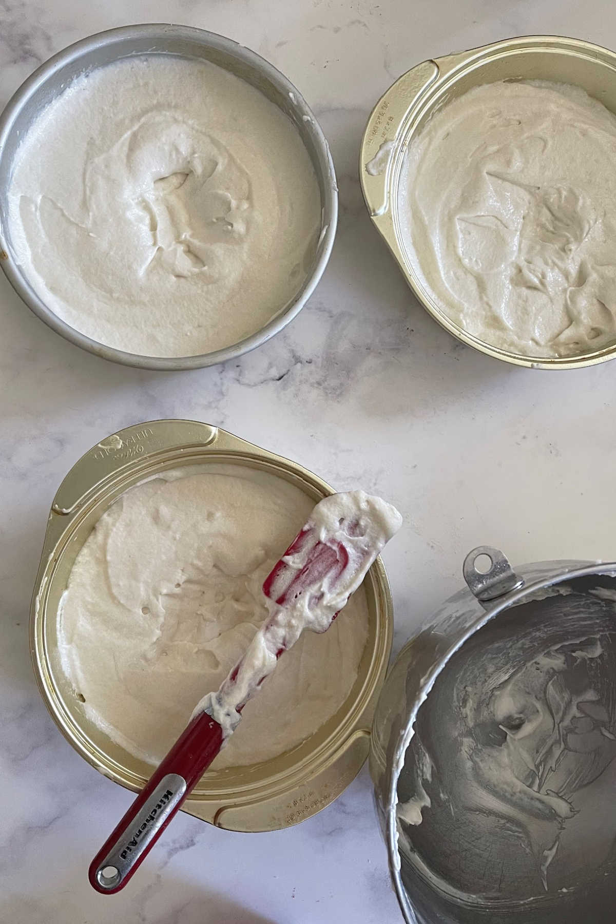 Cake batter is separated into 3 cake pans and ready to bake.