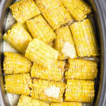 Overhead view of honey buttermilk corn on the cob in the slow cooker.