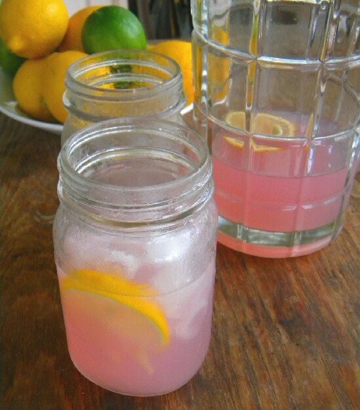 A Mason jar full of pink colored lavender lemonade cocktail.