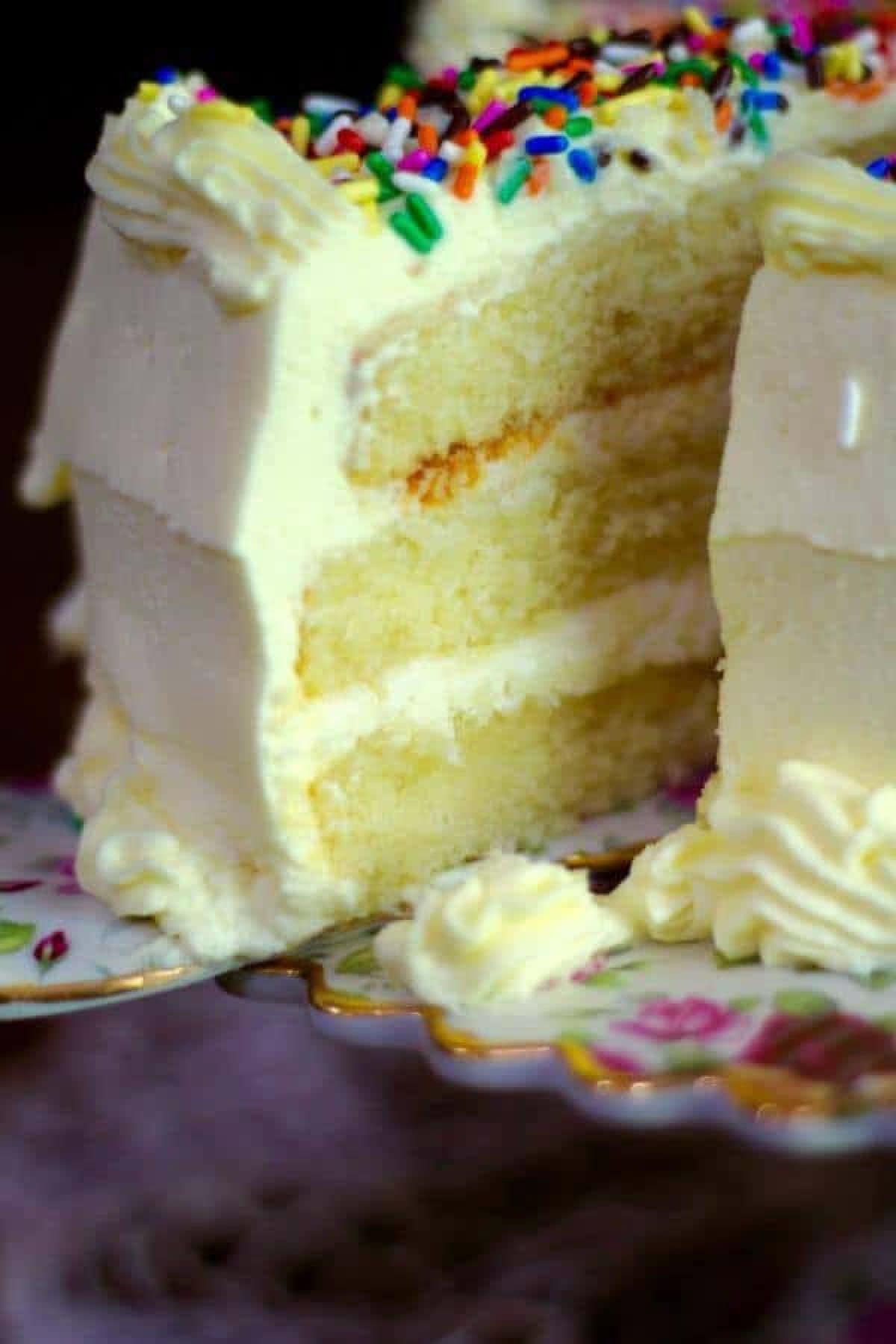 Closeup of a slice of cake being removed from the cake plate.