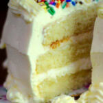 A closeup of a slice of lemon layer cake with a title text overlay for Pinterest.