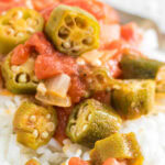 Closeup of okra and tomatoes over rice.