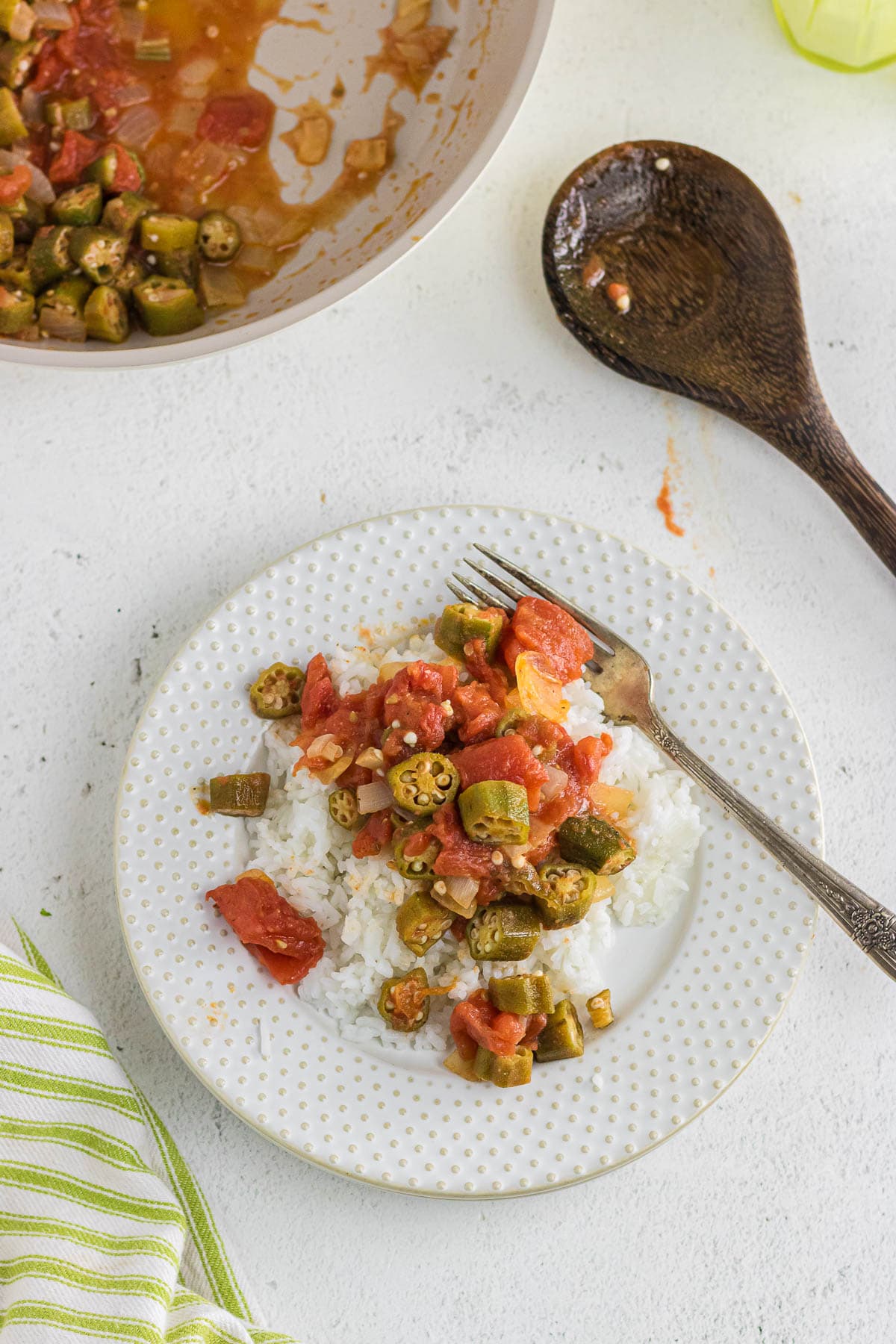 A plate with southern okra and tomatoes served over rice.