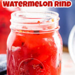 A jar of red, pickled watermelon rind with title text overlay for Pinterest.