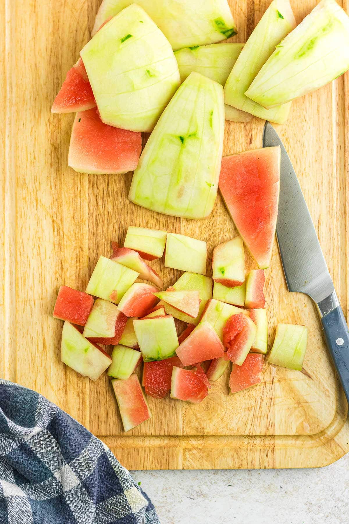 Dicing the watermelon rind into cubes.