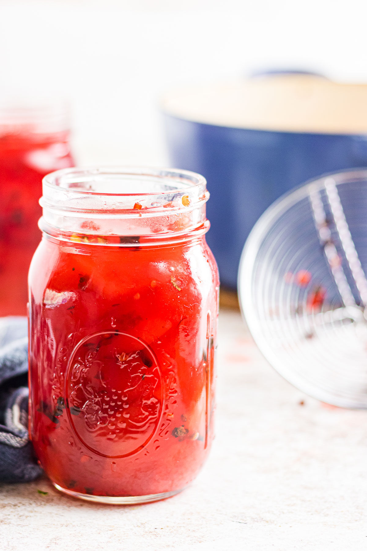 A close-up view of a mason jar with pickled watermelon rind.