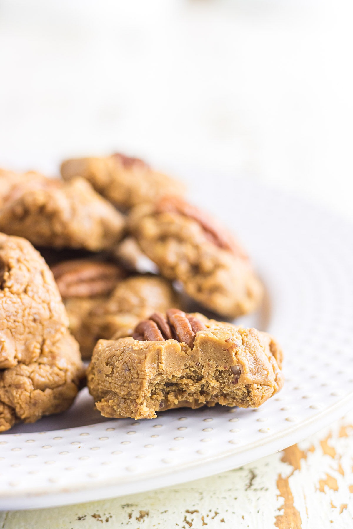 Creamy pecan pralines on a white plate.