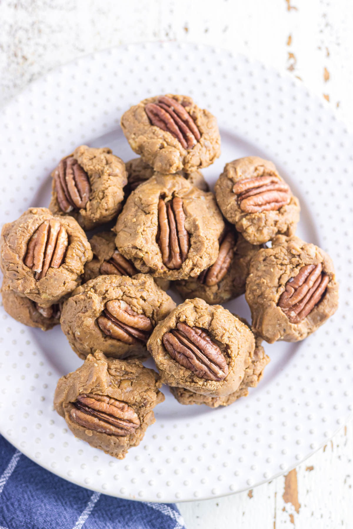 Overhead view of creamy pecan pralines on a plate.