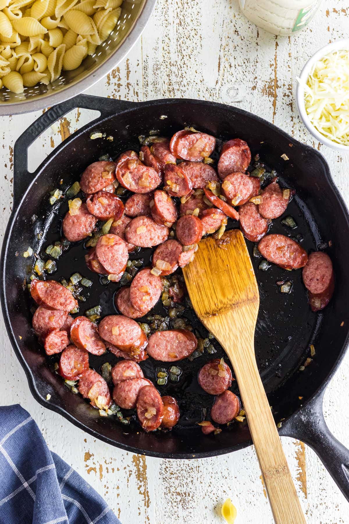 Sliced smoked sausage in a skillet.