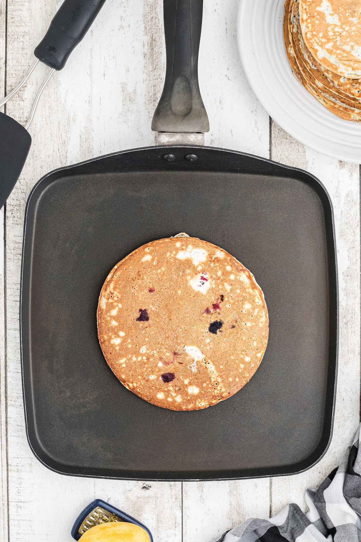 A finished pancake on a griddle.