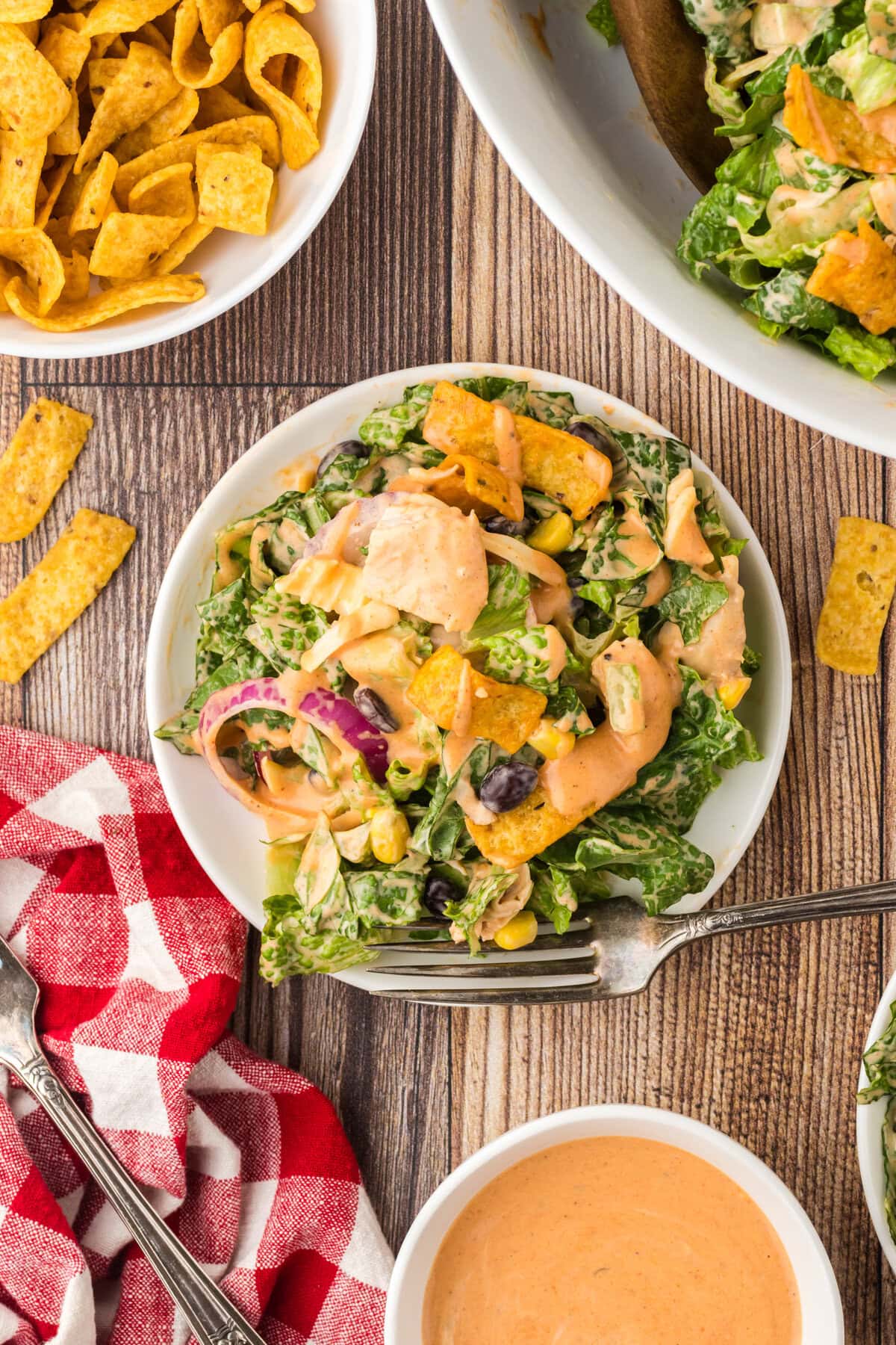 BBQ chicken salad on a serving plate with a fork.