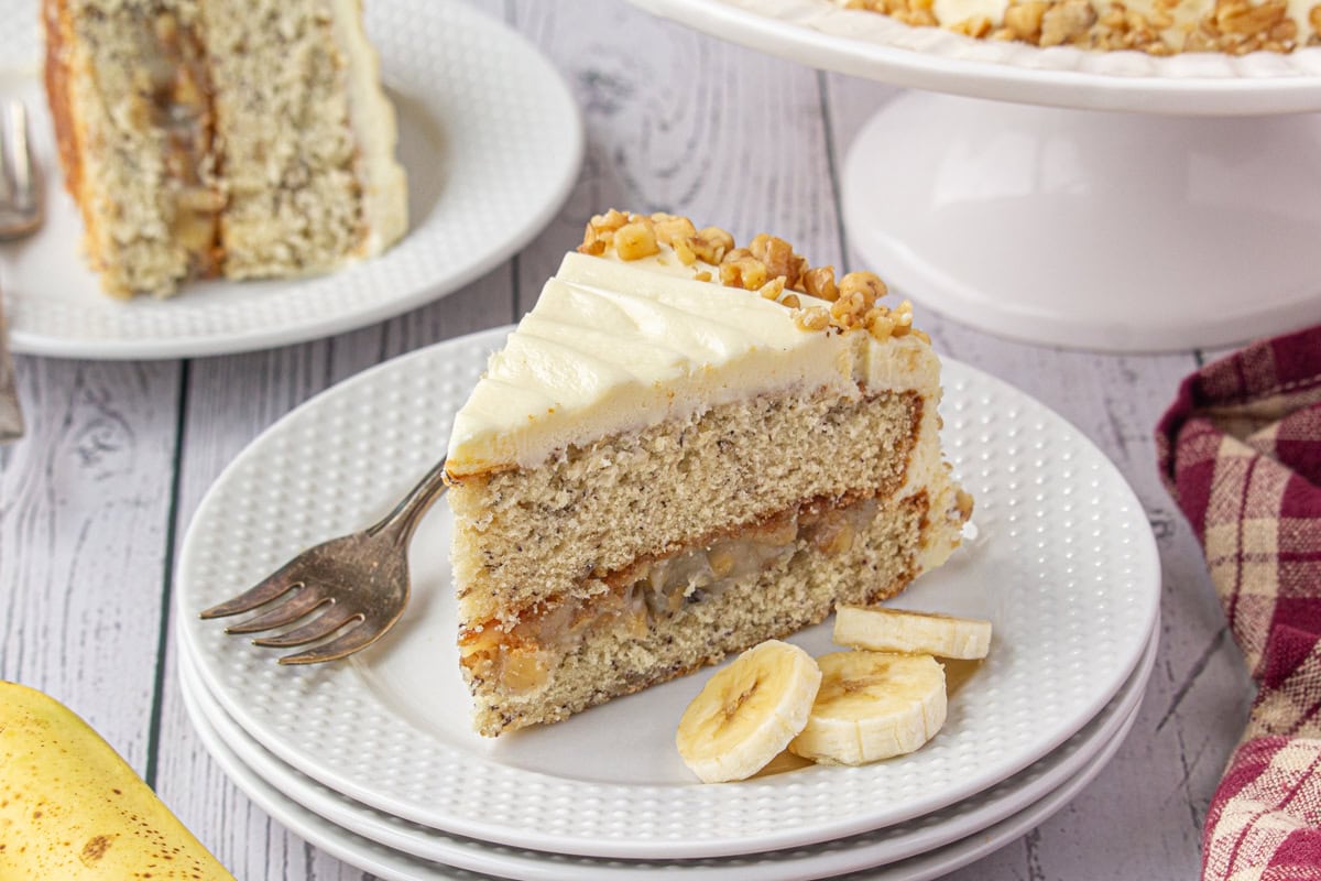 A slice of banana walnut cake on a plate.