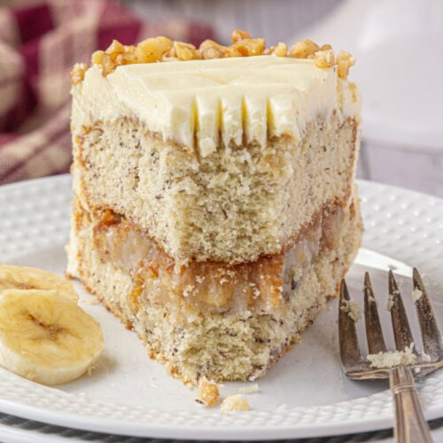 Banana walnut cake slice with a bite removed.