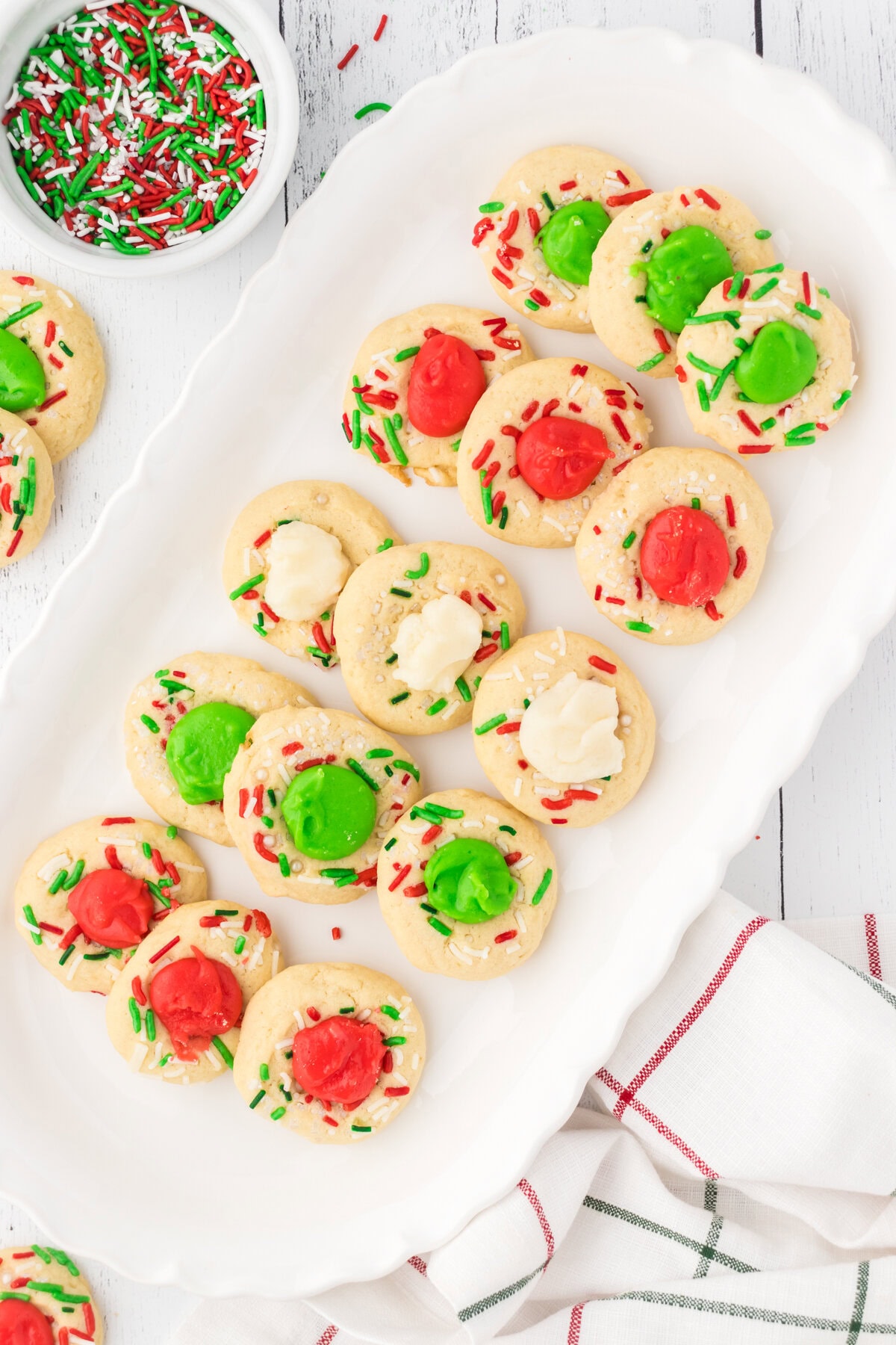 Christmas thumbprint cookies arranged on a serving platter.