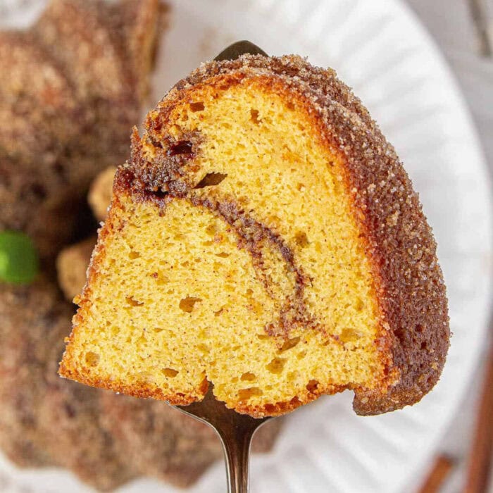 Slice of churro bundt cake showing the cinnamon swirl.