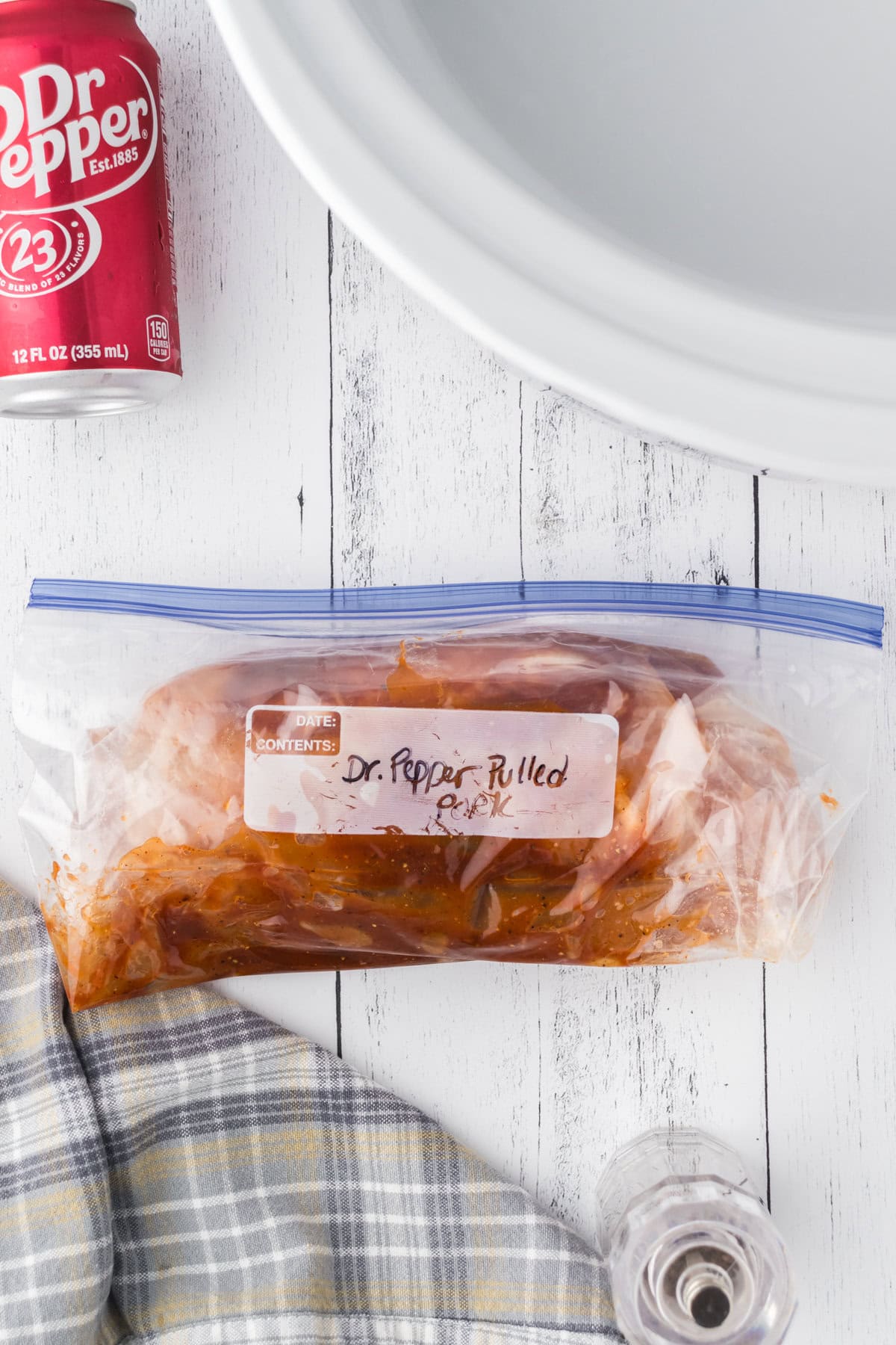 Dr Pepper pulled pork in a freezer bag labeled for storage.