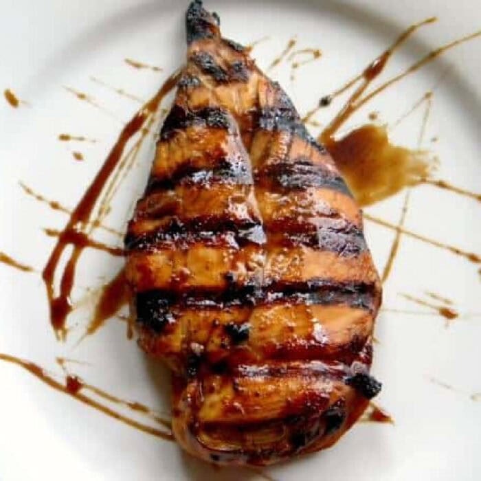Overhead view of a chicken breast with a sticky dr. pepper glaze.