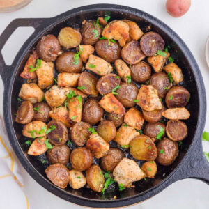 Overhead view of garlic butter chicken in a cast iron skillet.