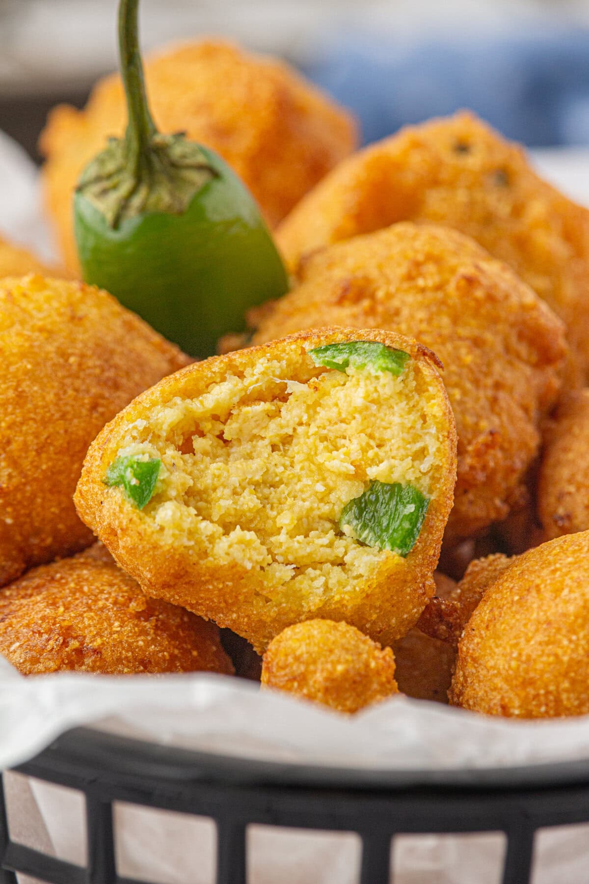 An up-close view of a Southern hushpuppy with a bite taken out of it.