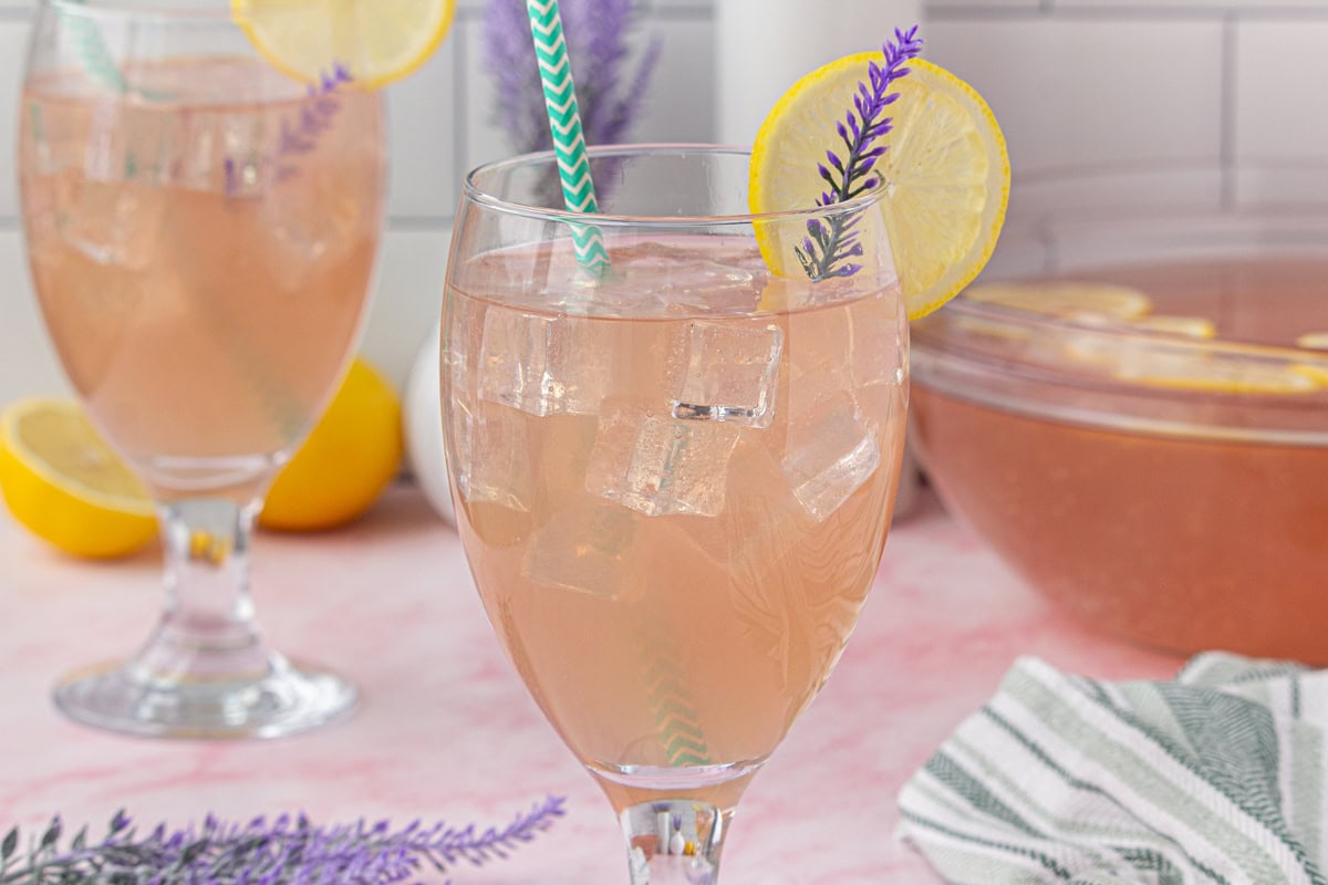 Two glasses of lavender punch on a counter top.